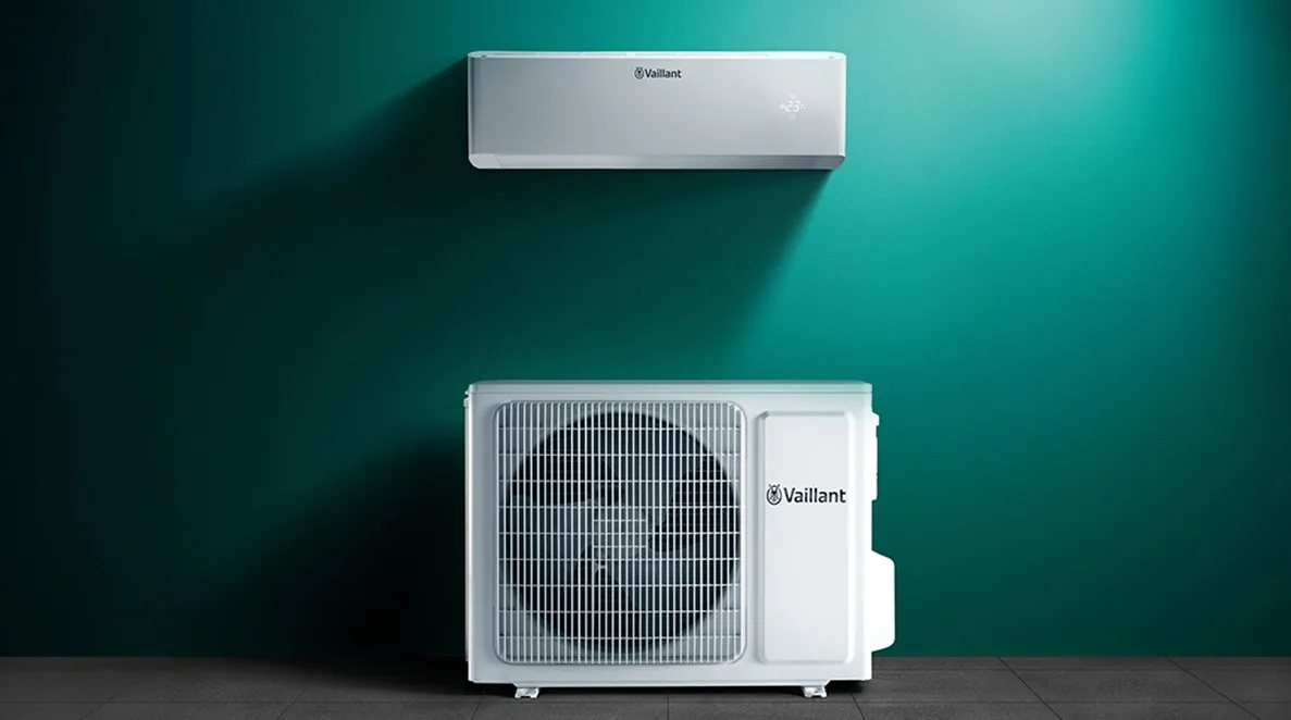 Vaillant airconditioningsysteem met binnen- en buitenunit op een groene muur.